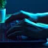 Hacker working on a laptop showing data breach