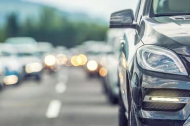 Traffic jam on the highway showing drivers' licences on dark web