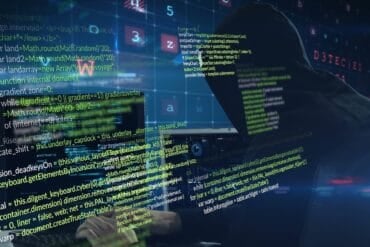 Hacker working on computer showing ransomware gang