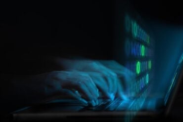 Hands on keyboard showing data breach at UK retailer