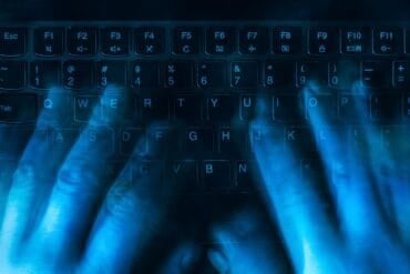 Hands on keyboard showing data breach