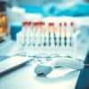 Bar codes scanner and blood sample tubes showing data breach at diagnostics lab