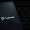 OpenAI logo on smartphone showing AI and recording device