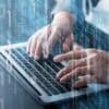 Developer on laptop showing AI coding tool exposes API keys
