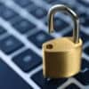 Metal padlock on laptop keyboard showing security flaw