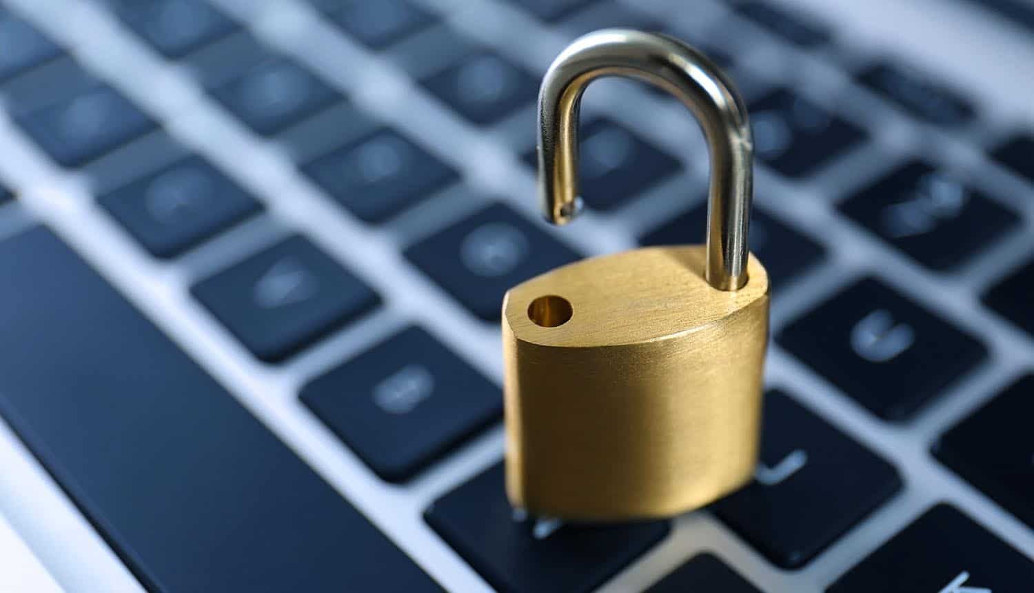 Metal padlock on laptop keyboard showing security flaw